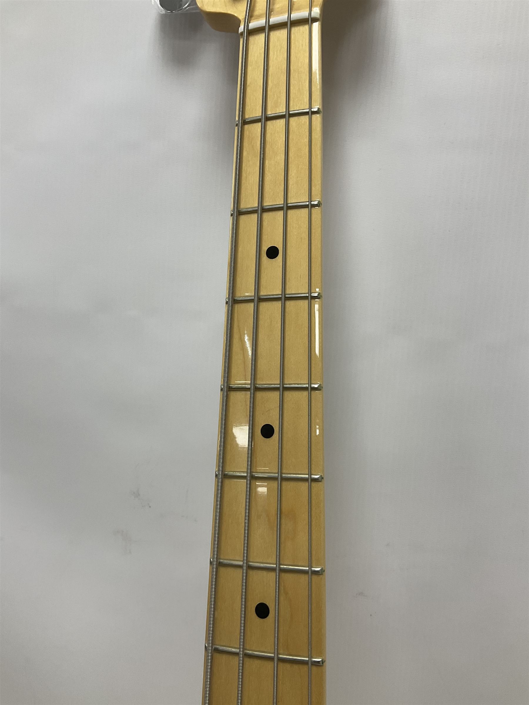 Fender Precision Bass guitar, in Olympic White finish with tortoiseshell effect scratchboard, serial no US15103092, in black Fender hard case with Fender strap and warranty card, guitar L116cm