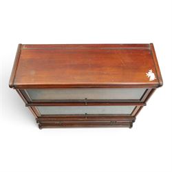 Globe Wernicke - early 20th century mahogany two-tier stacking library bookcase, fitted with glazed up-and-over doors, two drawers to the plinth base; together with a similar single-tier example (W87cm D27cm H54cm)