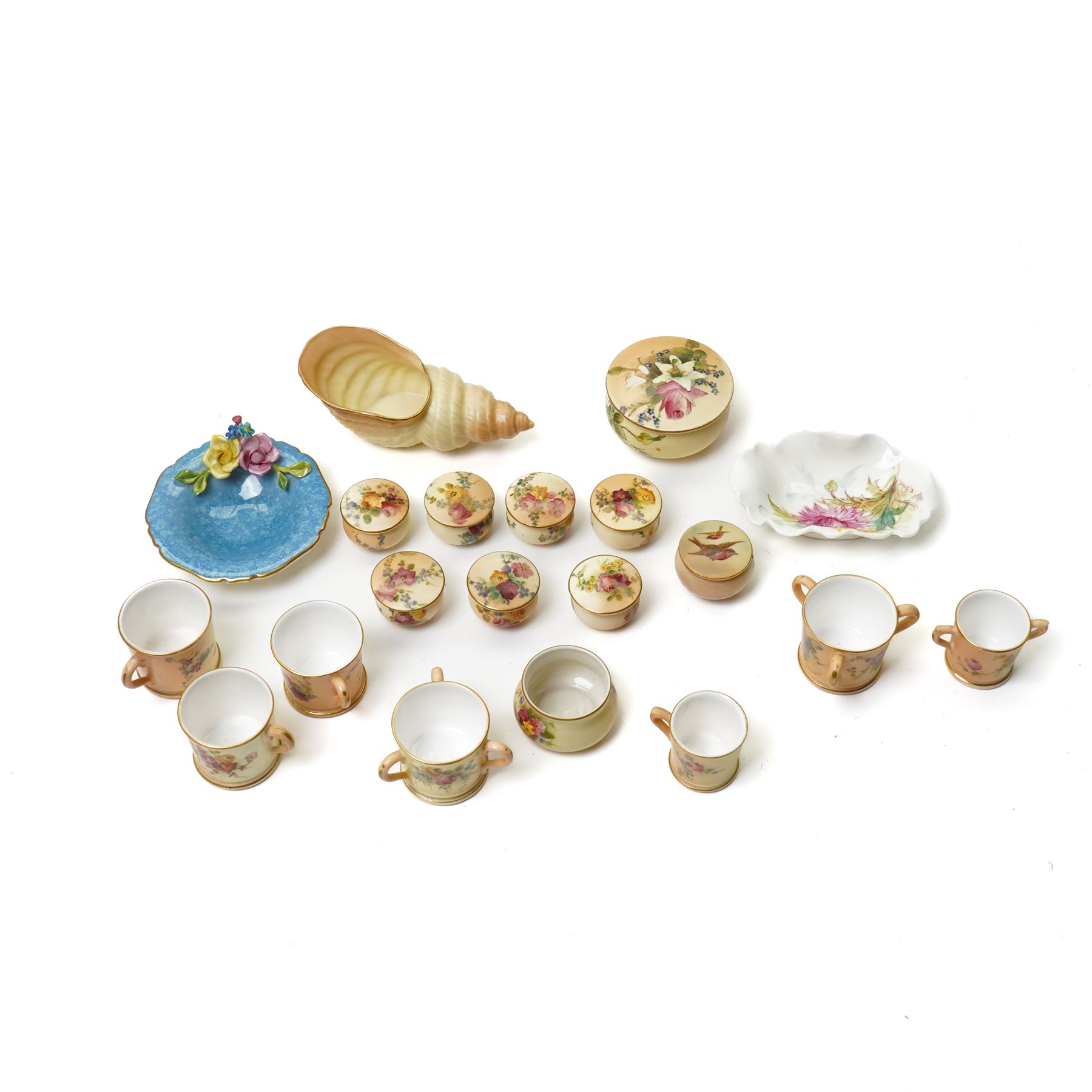 Large collection of miniature Royal Worcester hand-painted blush ivory wares, including shell shaped dish, and various covered trinket dishes, in glazed display case