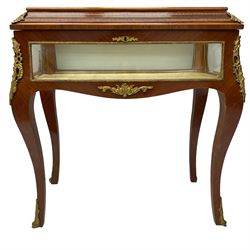 Mid-to-late 20th century French design Kingwood and walnut bijouterie cabinet, enclosed by cavetto moulded hinged lid with gilt metal foliage cast mounts and checkered stringing, on cabriole supports mounted by ornate cartouche castings and scrolled foliate terminal caps, lined in gold foliate pattern fabric and glazed with bevelled glass
