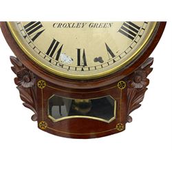 A late 19th century drop dial fusee wall clock in a mahogany case with brass inlay and a carved representation of flowers flanking the glazed pendulum viewing glass, with case side door and pendulum adjustment door, 12