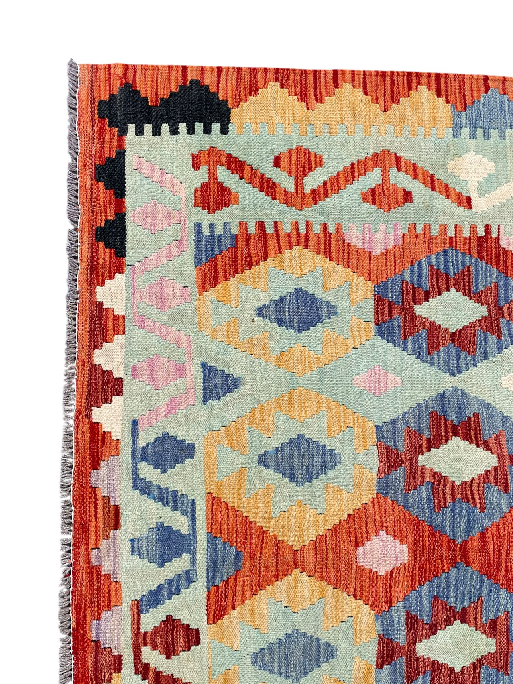 Large Kilim carpet, overall geometric design, decorated with lozenges within a tailing border, geometric guard stripes 