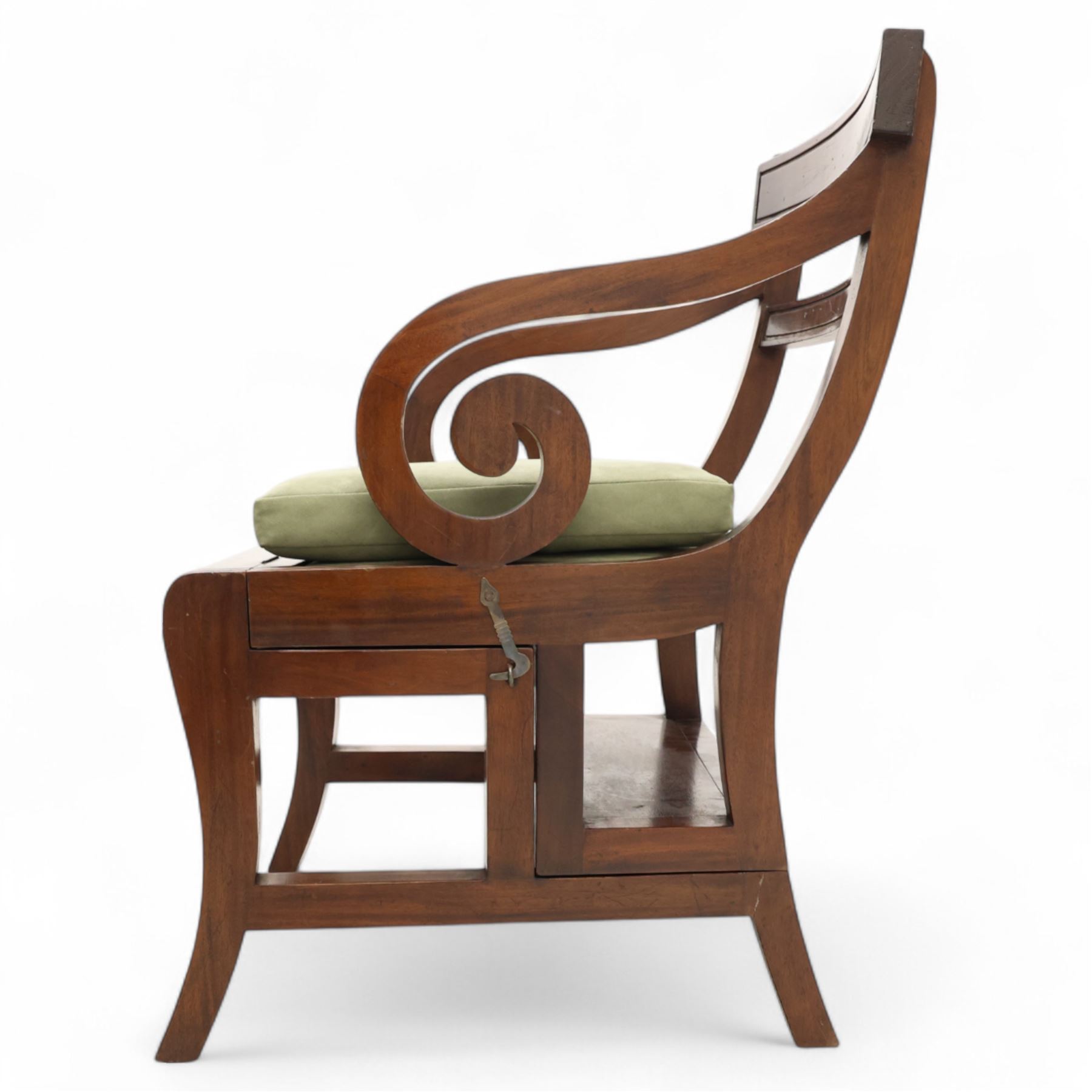 In the manner of Morgan & Sanders - early 20th century Regency design mahogany metaphoric library chair and steps, rectangular panelled top-rail with applied roundels with scrolling arms and upholstered seat and cushion, hinged and folding design transforming into four carpeted steps

Reference: The present lot is based on a design for a metamorphic library chair published by Morgan & Saunders circa 1810, P.Agius, Ackermann's Regency Furniture & Interiors, plate 29, page 60