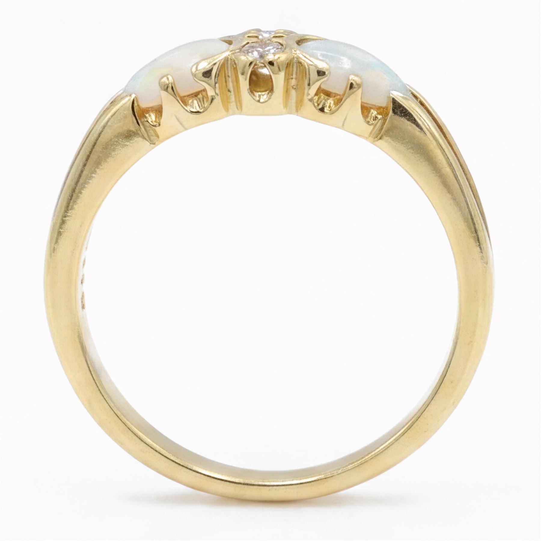 18ct gold opal and diamond four stone ring, two round brilliant cut diamonds, with a single cabochon pear cut opal set either side, London 1994