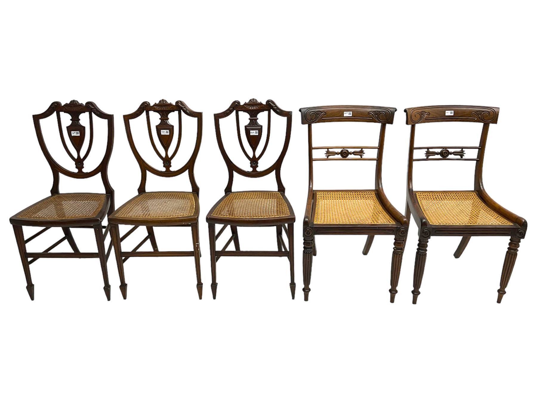Pair of Regency rosewood framed side chairs, carved back rails over cane seat, raised on reeded supports (W46cm D50cm H84cm); set of three Edwardian walnut cane seat bedroom chairs, carved shield back (W41cm H88cm)