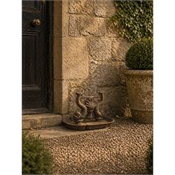 Victorian cast iron boot scraper, supported by two dolphins with central shell motif