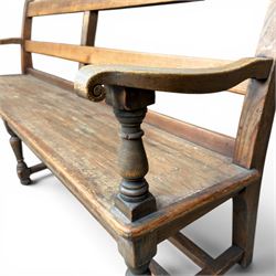 Early 20th century pine and oak bench seat, stained pine rail back frame with shaped oak arms