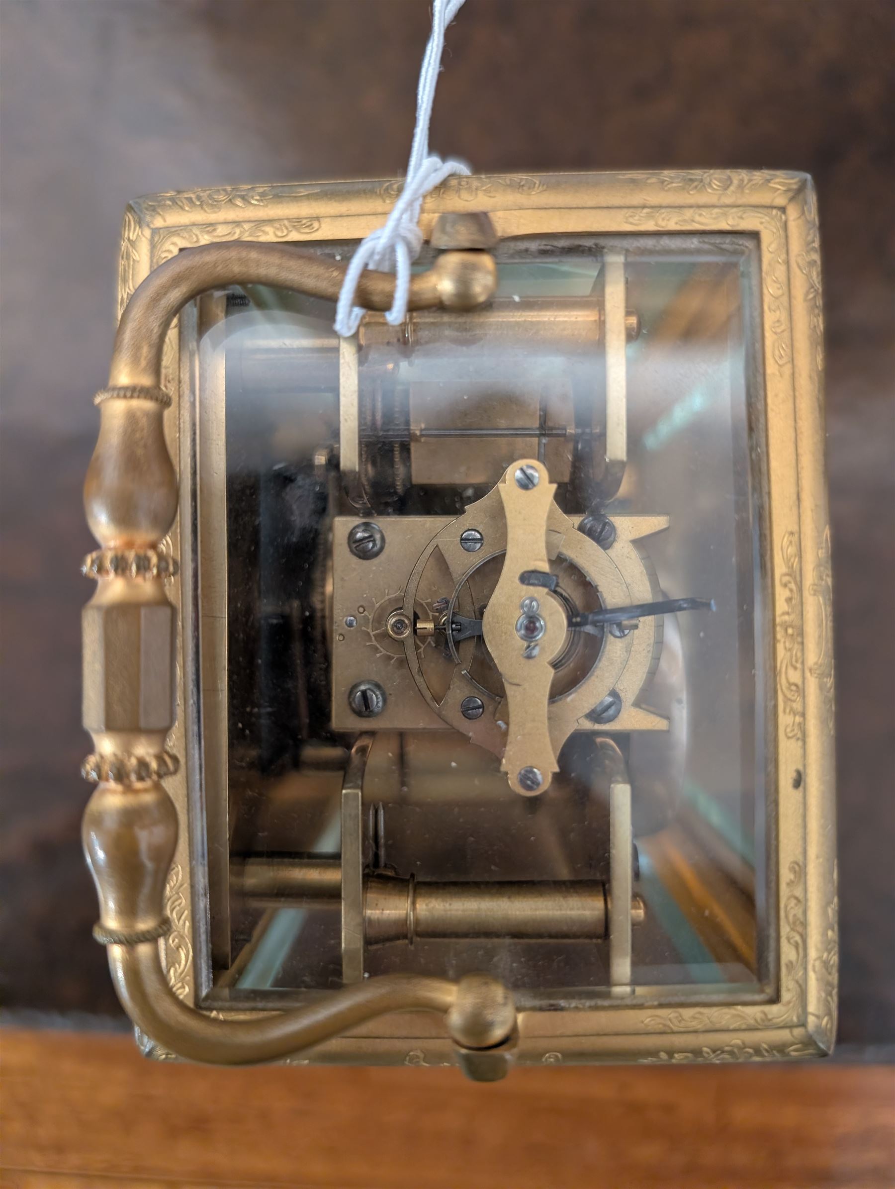 Late 19th century French 8-day brass cased carriage clock, Henry Marc of Paris, the gorge case with swing handle and four bevelled glass panels, white enamelled dial with Roman numerals and minute markers and steel hands, the two train movement with platform lever escapement, hour striking on a bell, with key