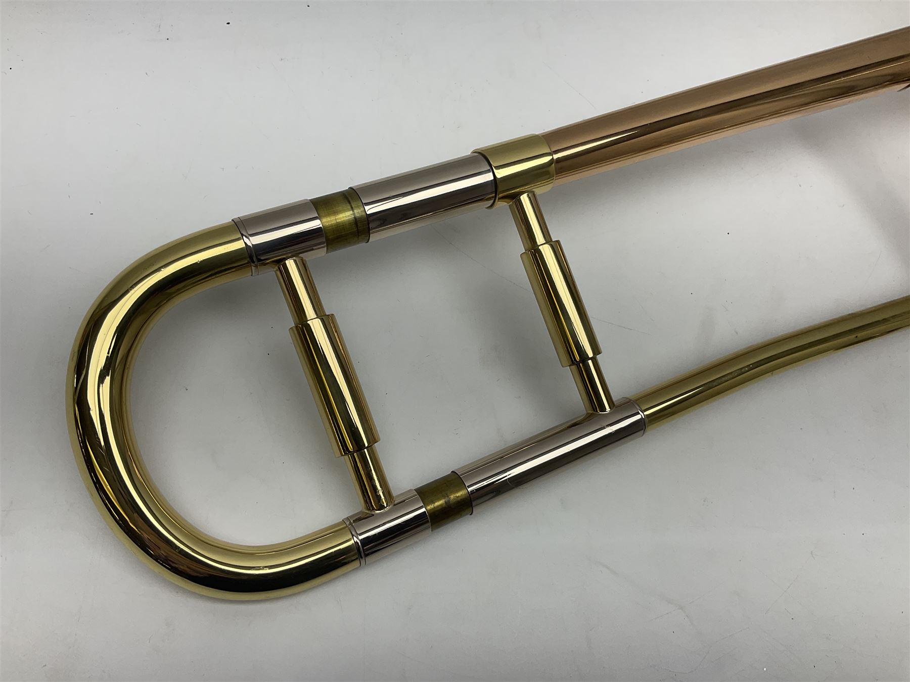 Sebastian Bucklet Aquae Sulis copper and brass trombone No.0910004; in lightweight carrying case; and Kinsman folding tubular chrome music stand in case (2)