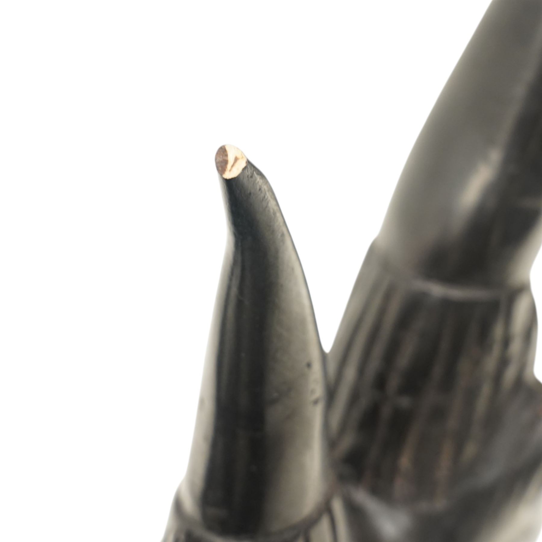 African carved hardwood ebonised figures of a rhinoceros and hippopotamus, each with stylised incised detail and polished dark finish, largest H 61cm, W 91cm)