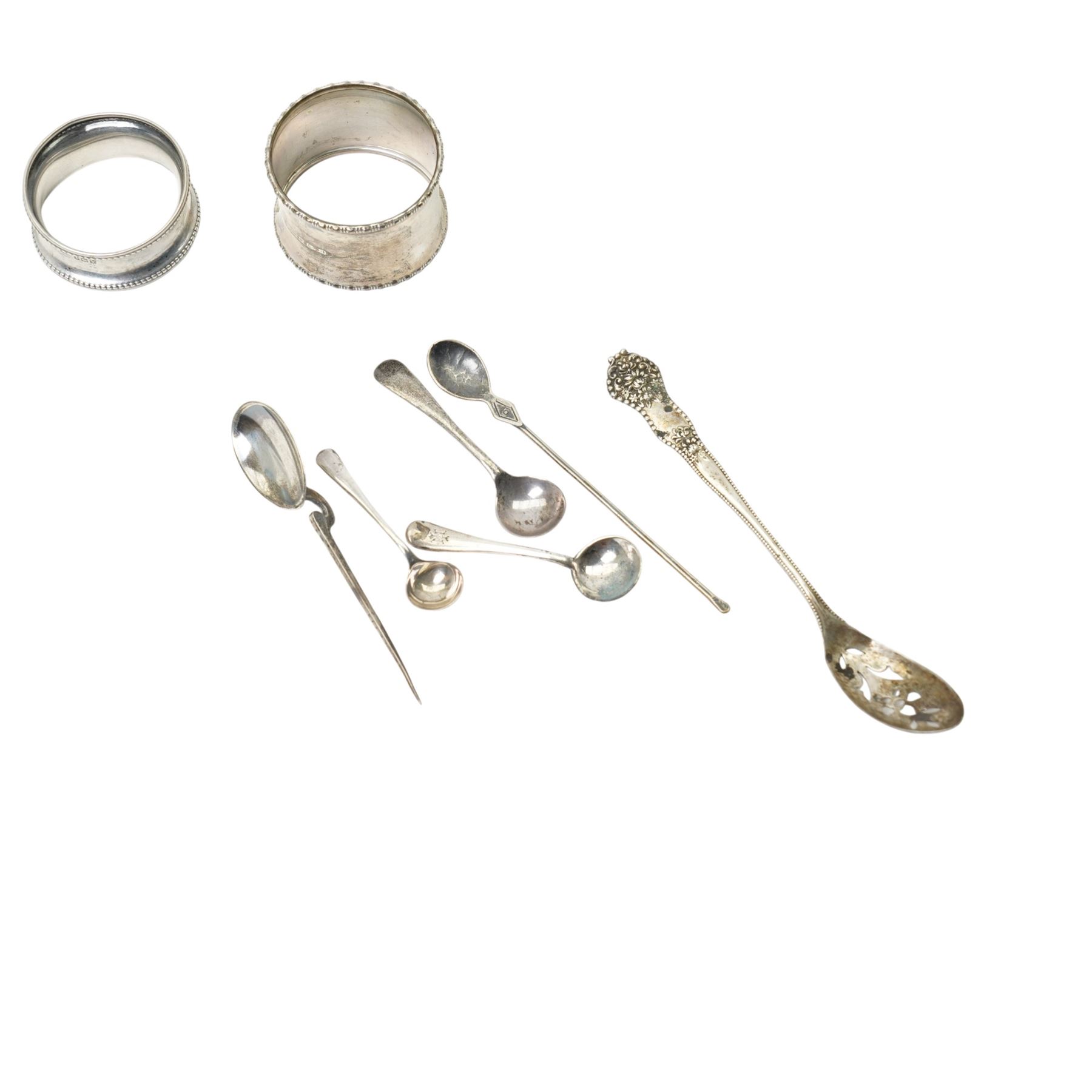 Two silver napkin rings, silver mirror frame and various silver spoons