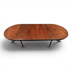 Regency design mahogany extending twin pedestal dining table with two additional leaves, raised on splayed supports terminating brass paw feet
Extends to 268cm