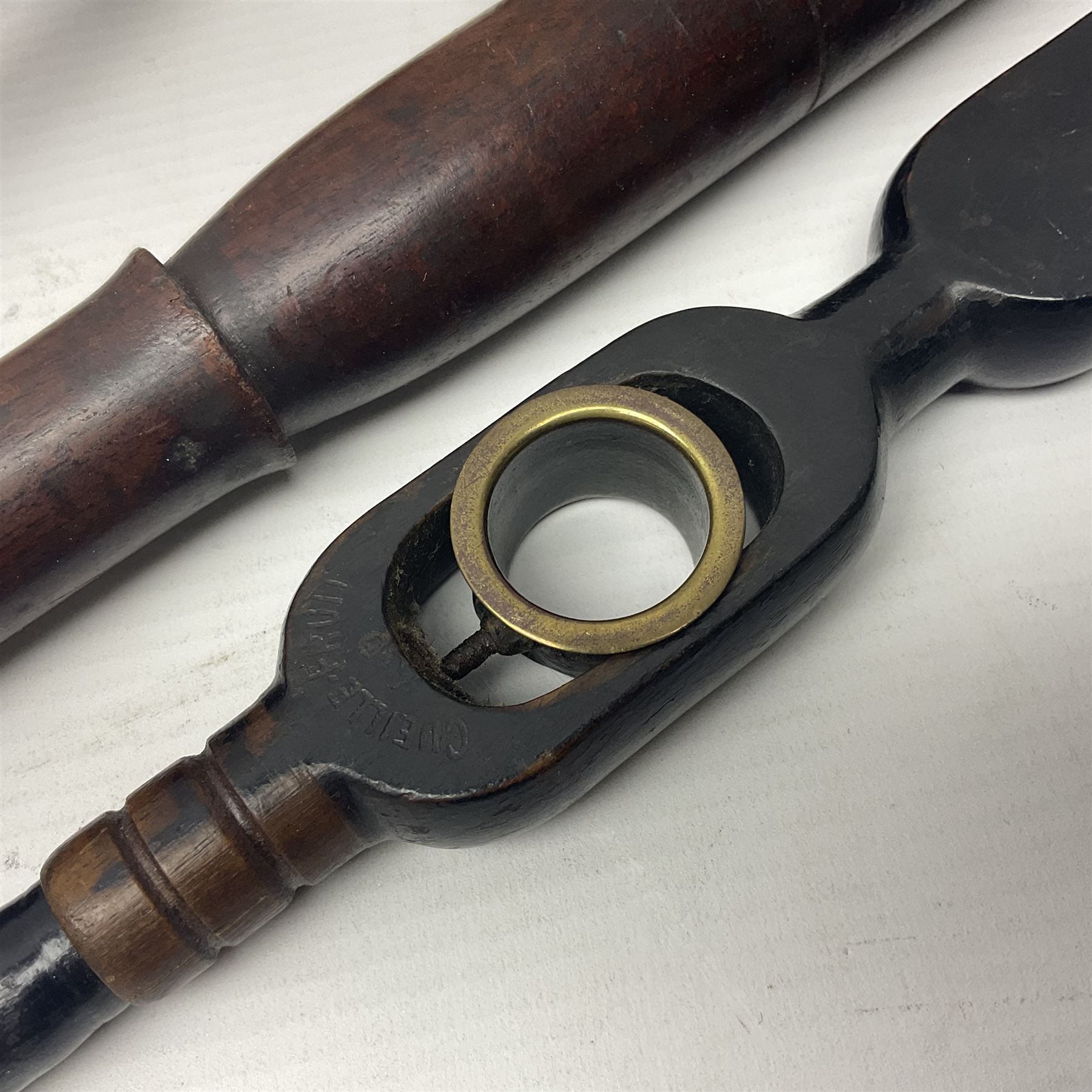 Two late 19th century fruit picker canes, the first example a French ebonised bamboo cane, with pair of fruit scissors to base, the handle stamped Cueille Fruit, the second example with grabbing action, the cap stamped A C Harris, Leicester, together with two other 19th century canes, one with fork and the other with hoe
