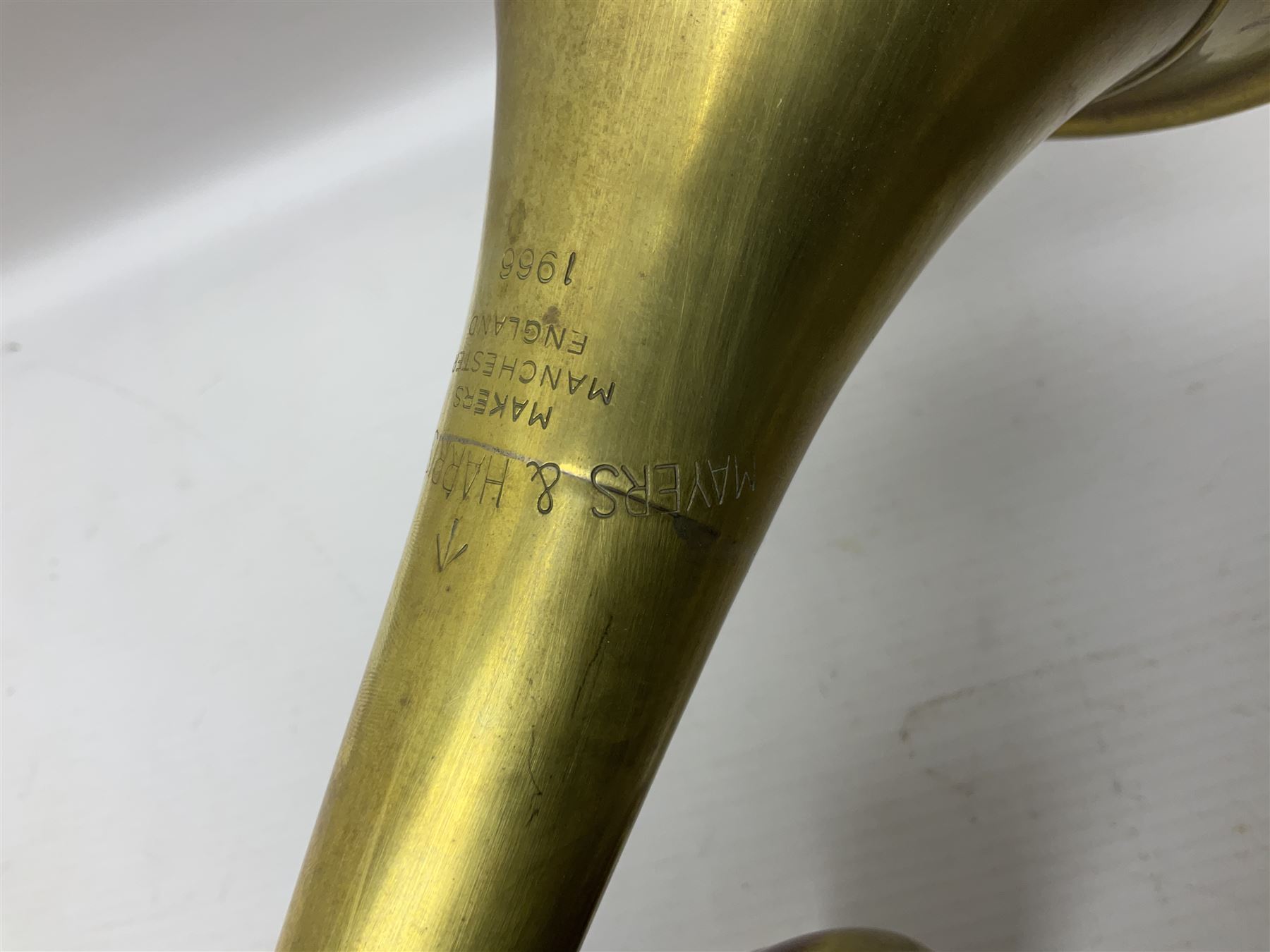 Two military brass bugles by Mayers and Harrison Ltd. Manchester each with crows foot mark and dated 1966; both with multi-coloured cord and tassels, longest 52.5cm (2)