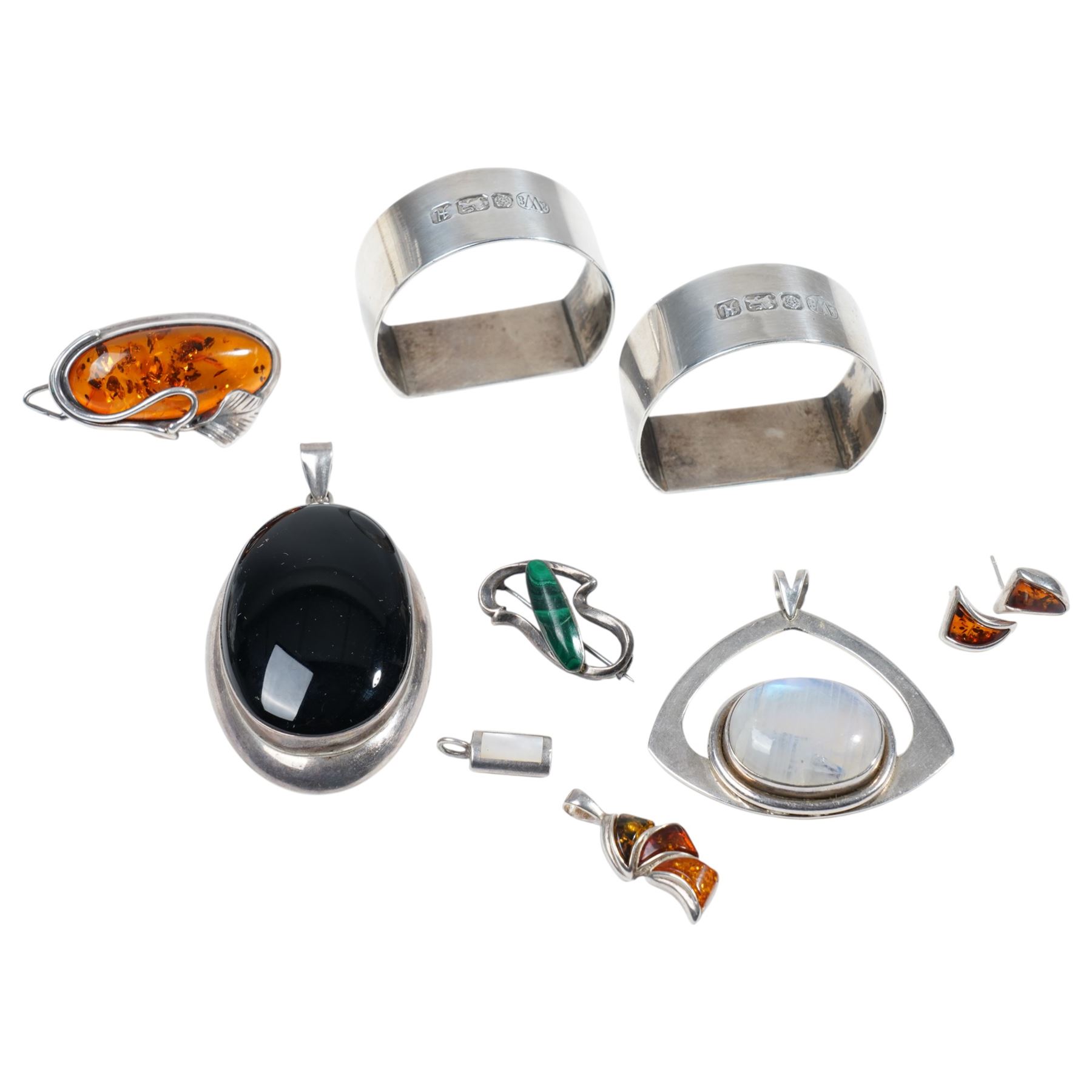 Two silver serviette rings, possibly by Warriss & Co, Sheffield 1982 and silver stone set jewellery including an amber set brooch/ pendant and pair of earrings, malachite brooch etc 