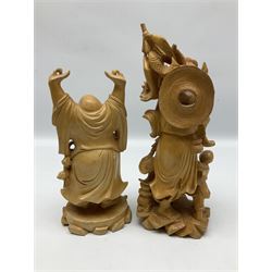 Two Japanese carved wood okimonos, to include example modelled as a fisherman holding his catch in one hand and pipe in the other, and his child, tallest H25cm