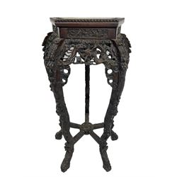 Early 20th century Chinese carved hardwood jardinière stand, the bead carved pentagon top with marble inset, carved and pierced with dragons and scrolling motifs, five shaped supports joined by stretches carved with flower head motifs