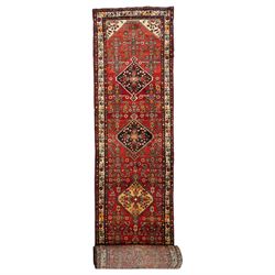 Large Persian Qashqai runner rug, the red ground decorated with navy and ivory lozenge med...