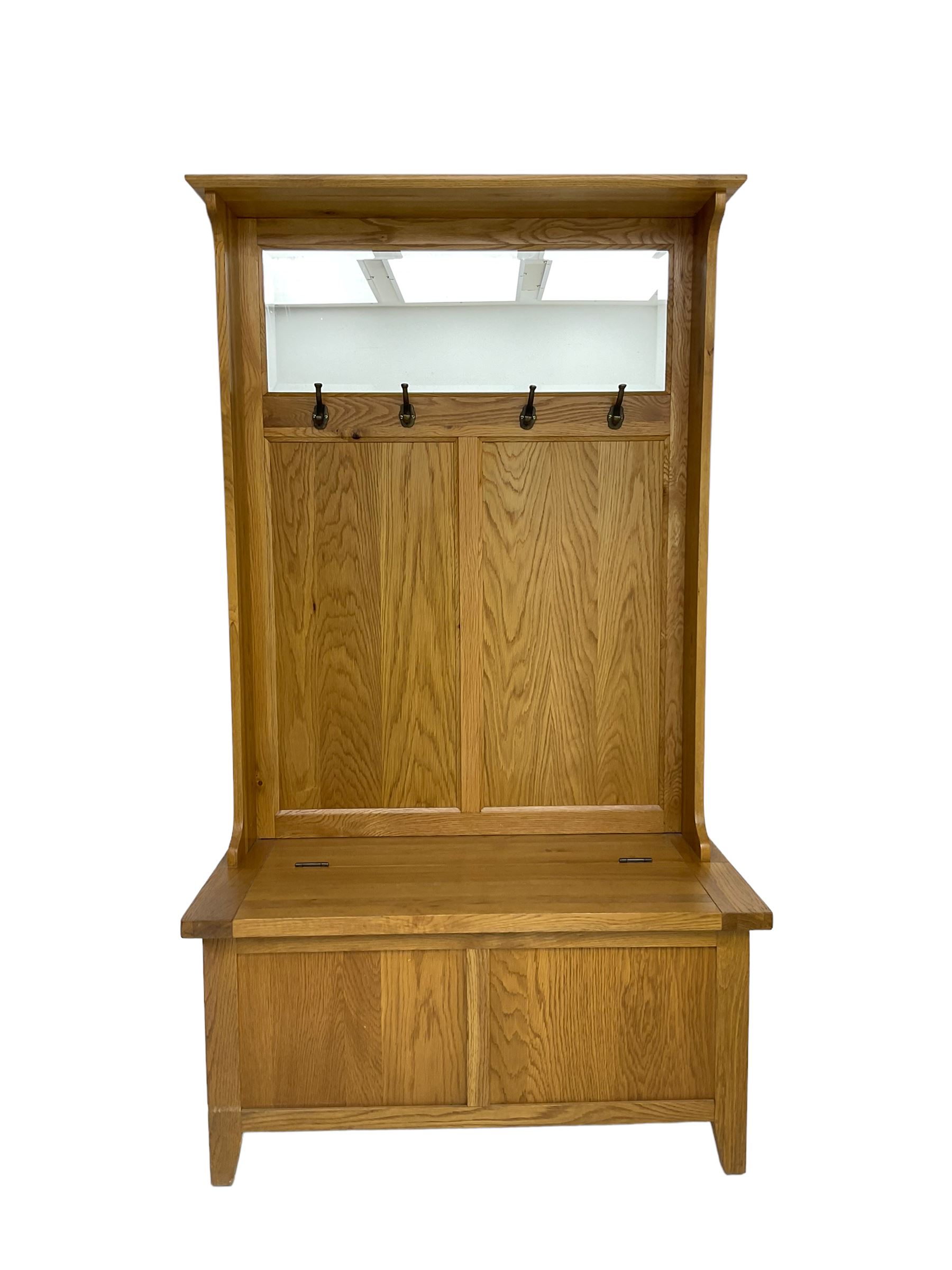 Oak mirror-back hall bench, projecting cornice, rectangular bevelled plate over four coat hooks, hinged box seat compartment with panelled front, on square tapering feet