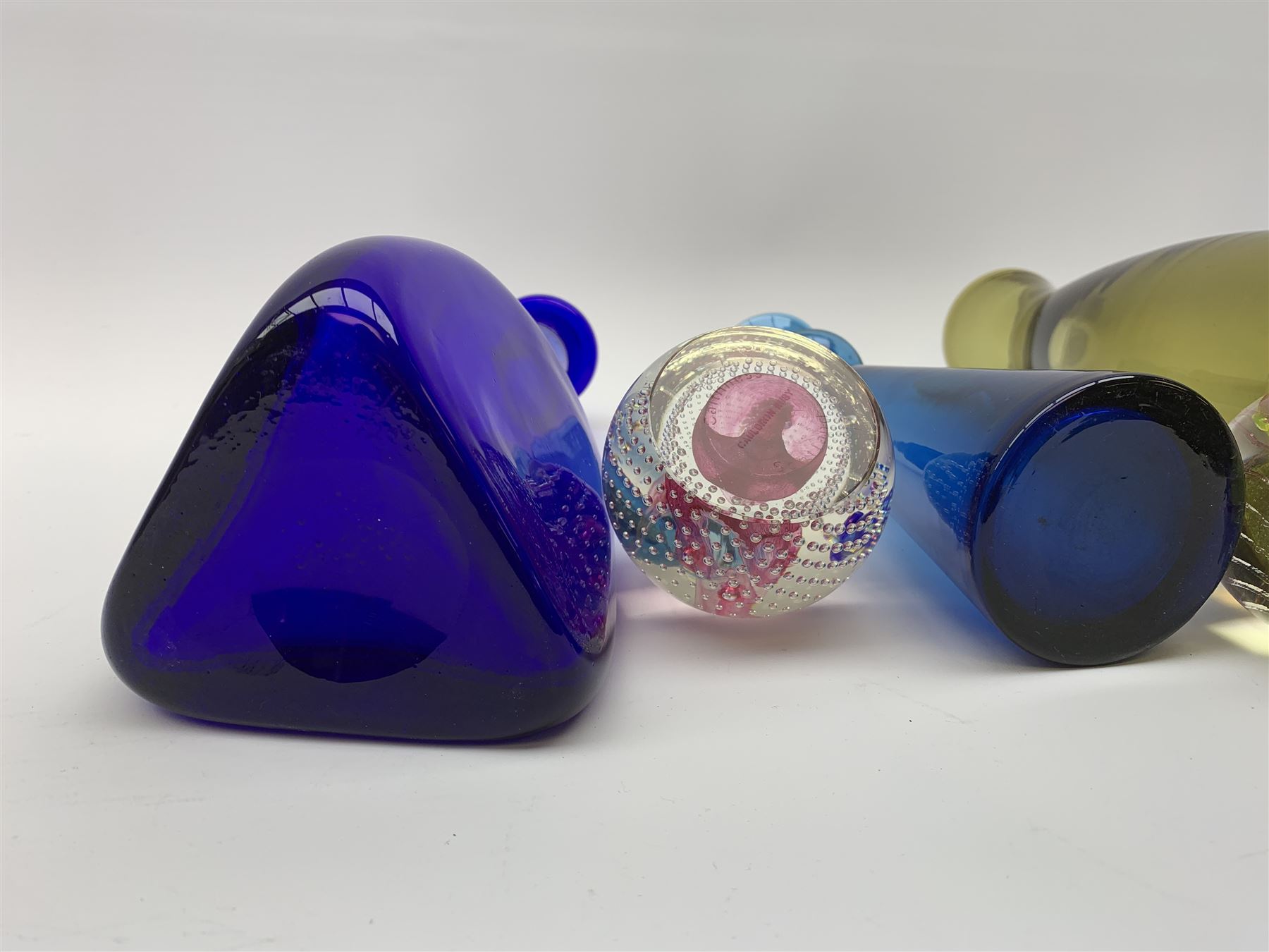 Kosta Boda decanter bottle, c1960, designed by Erik Höglund (1932-1998), in a triangular pressed form, engraved pattern number H1250/250, a clear glass decanter with bubble inclusion, probably Kosta Boda, two Scandinavian glass vases, ochra glass vase, Isle of Wight glass paperweight, Caithness glass paperweight & vase (8)