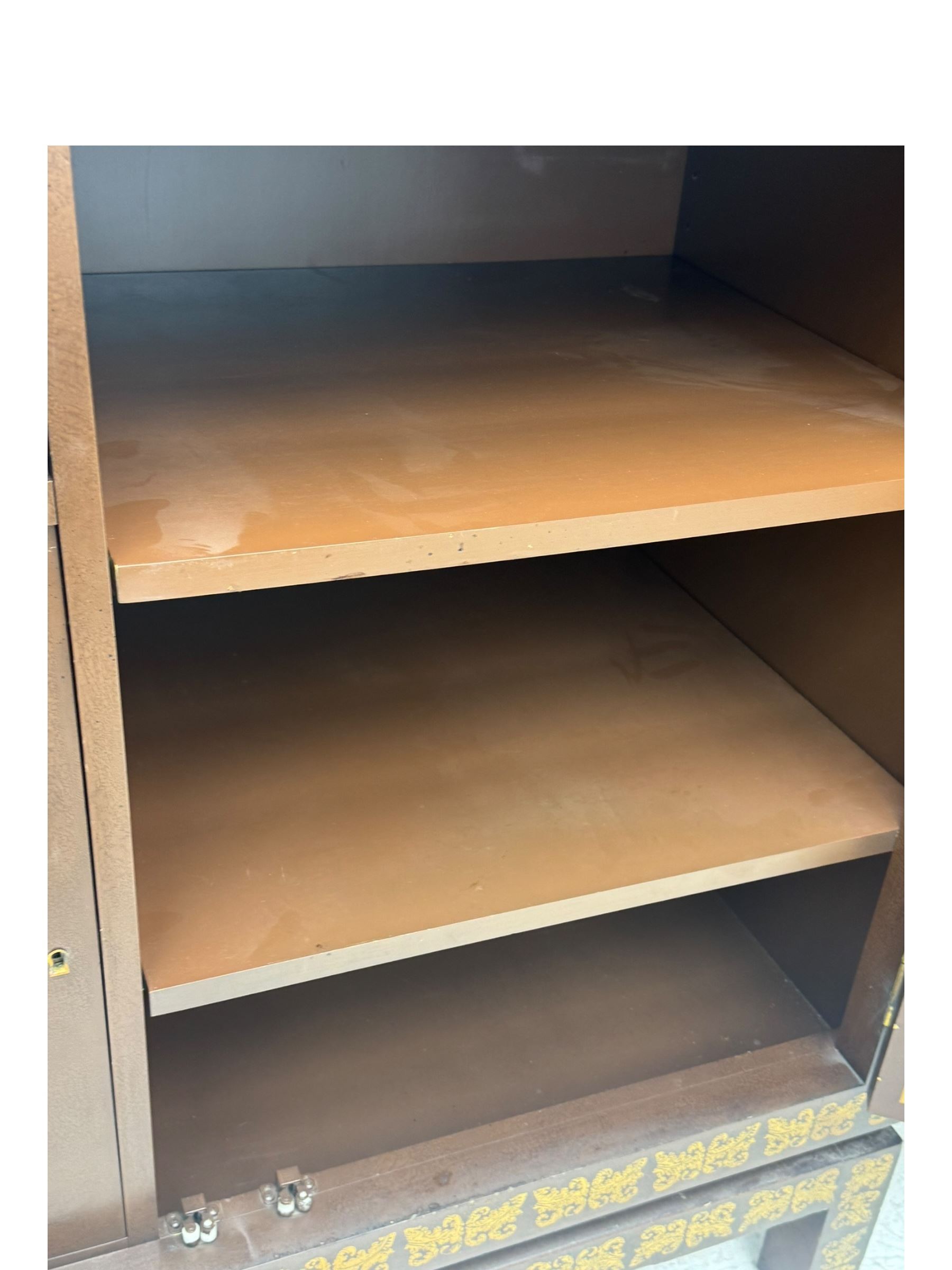 Chinese brown lacquered cocktail cabinet, decorated with gilt scenes of a traditional landscape with figures, pagodas, and mountainous scenery, double doors opening to reveal fitted interior with mirrored back, wine rack, shelves and cupboard, raised on square supports