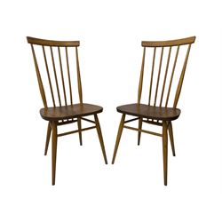 Ercol - pair of mid-20th century highback 'Windsor' chairs, curved top rail over six vertical spindles and shaped seat, on tapering cylindrical supports with stretchers