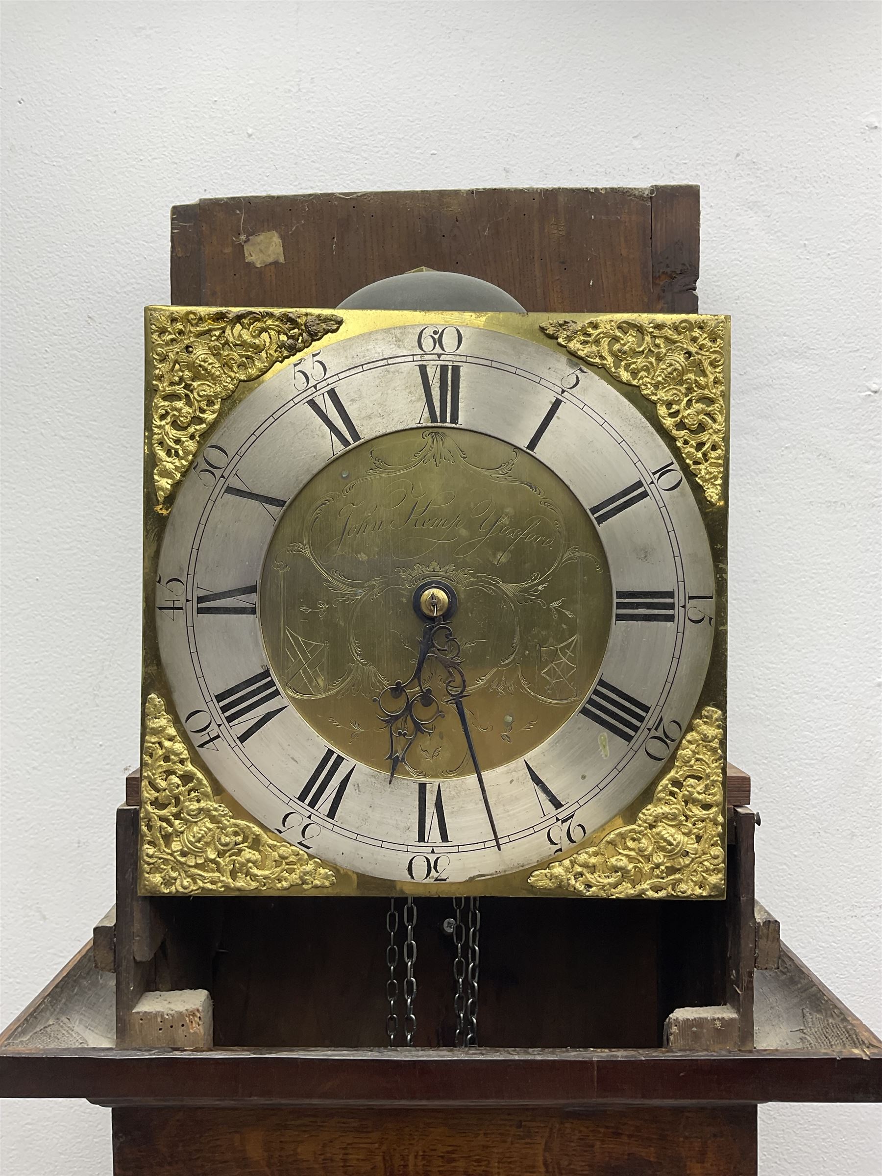 John Kemp of Yoxford (Suffolk) - 18th century oak 30 hour longcase clock c1770, with a later box top and finials, square hood door with attached pilasters and gesso capitals, long flat topped trunk door with a rectangular plinth and bracket feet, brass dial with cast spandrels and engraved dial centre, silvered chapter ring with Roman numerals and five minute Arabic's, with matching steel hands, birdcage chain driven movement with a recoil anchor escapement and count wheel striking. With weight and pendulum.
