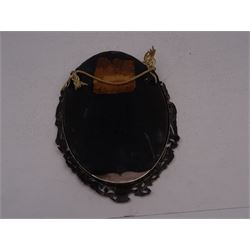 Continental silver miniature dressing table/wall mirror, of oval form with bevelled mirror plate, surrounded by a bead and dart rim, with pierced scrolling floral border with a standing cavalier to either side and the bust of a cavalier to the base, H17.7cm