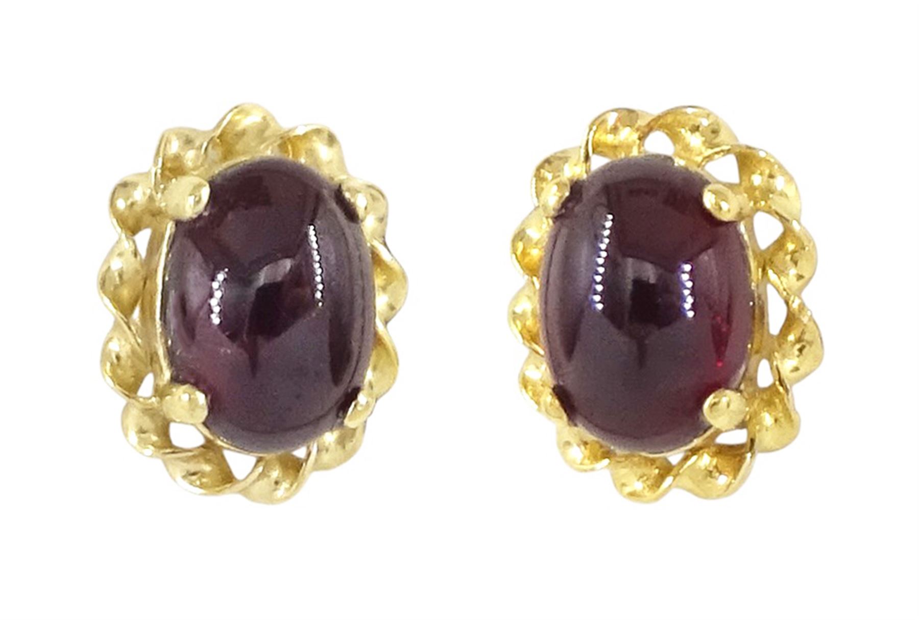 Pair of 9ct gold cabochon garnet stud earrings, stamped
