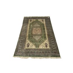 Persian design green and beige ground carpet, the field decorated with square medallion and repeating stylised flower heads, highly patterned multi-band border