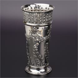 Victorian silver cylindrical vase embossed with garlands and foliage, the collar with a ba...