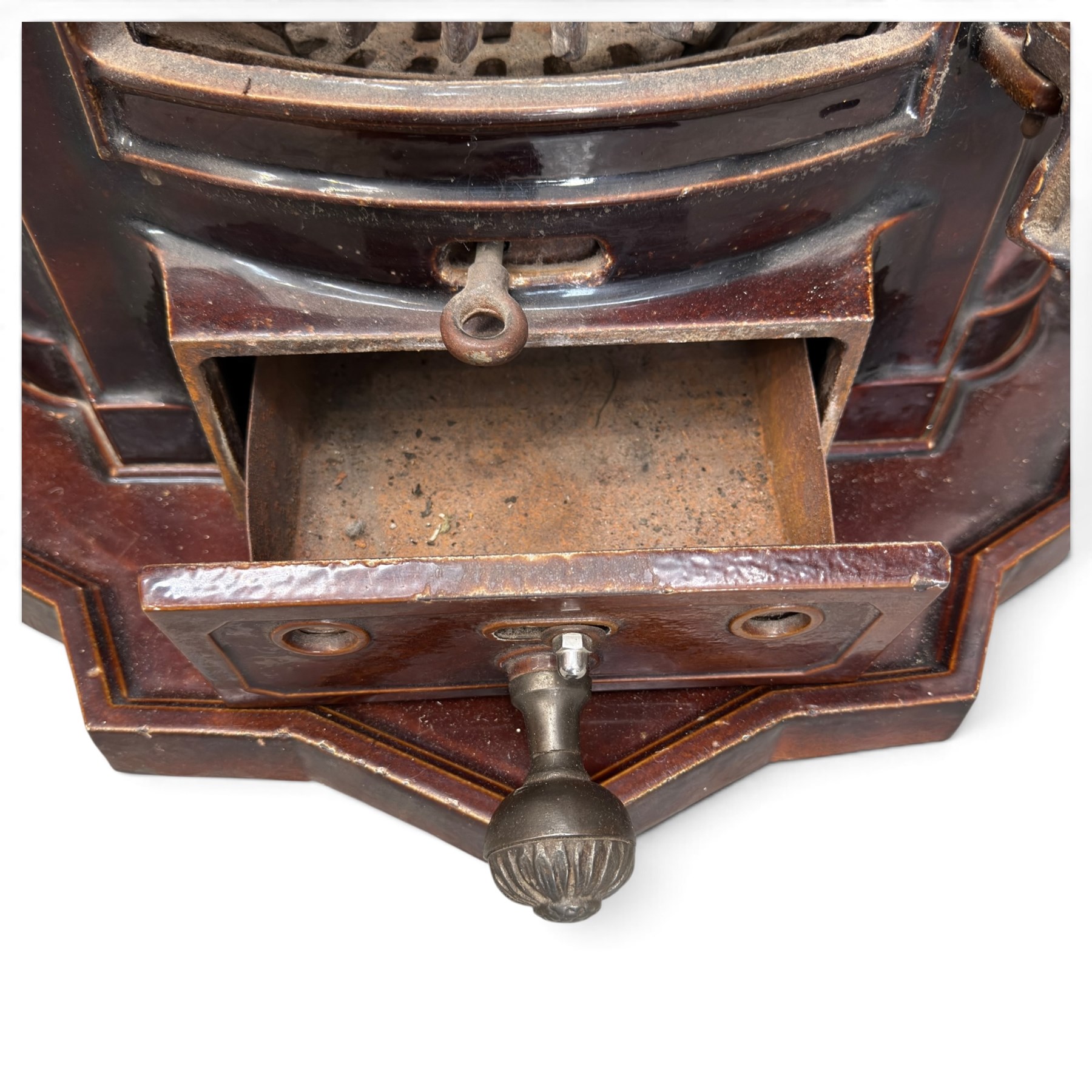 Deville & Cie of Charleville - early 20th century Art Deco cast iron and burgundy enamel 'Cristal' wood burning stove, hinged vent over lattice glazed door and ash drawer, on shaped geometric base, circa 1920
