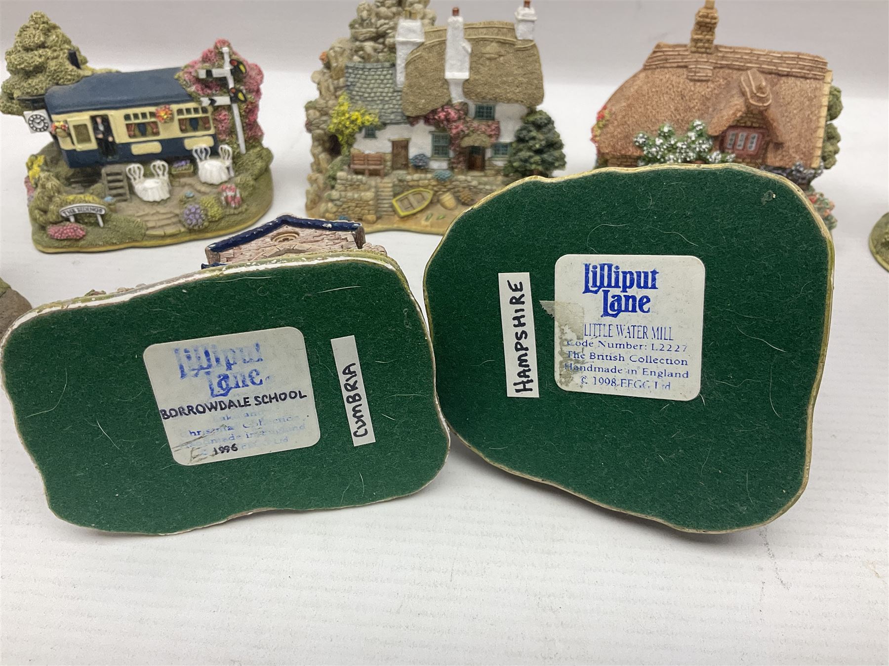 Eighteen Lilliput Lanes, including The Penny Farthing, The Pigsty, Borrowdale School, Fairy Cake Tearoom, An Apple a Day,Ladybird Cottage etc, all with original boxes 