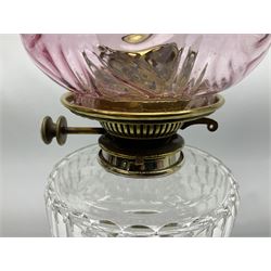 20th century Hawksworth, Eyre & Co silver plated oil lamp, the octagonal stepped base with engraved dedication, leading to an octagonal column supporting a faceted clear glass reservoir, Hinks Duplex burner, clear glass chimney, and cranberry glass shade, overall H71.5cm
