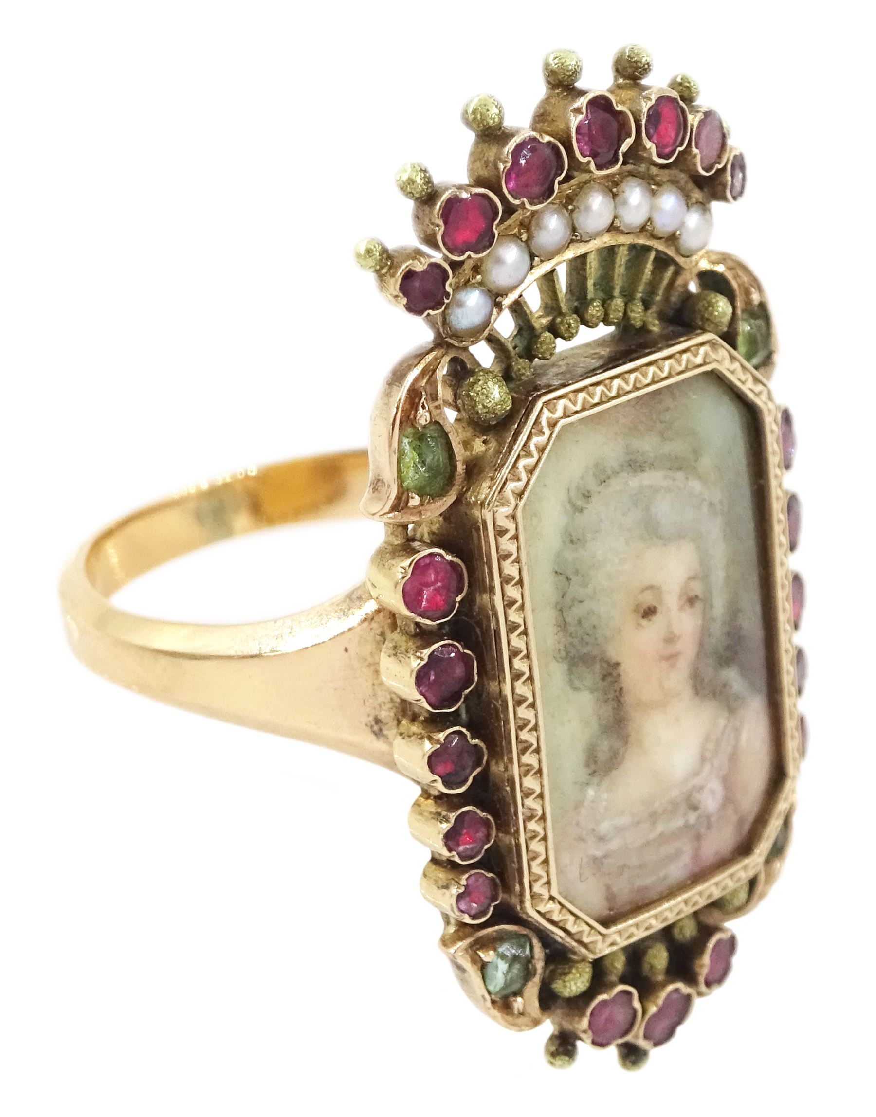 19th century 18ct gold portrait ring, set with an octagonal miniature of a woman wearing a pink dress on ivory, under a glazed panel, within a milled bezel and garnet surround, surmounted by a coronet set with seed pearls and further garnets. This lot has been registered for sale under Section 10 of the APHA Ivory Act