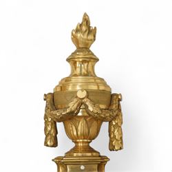 Pair of 19th-century Louis XVI-style ormolu rams-headed two-light wall appliques, the arms joined by a garland of laurel leaves, the half fluted stem surmounted by a vase with laurel garland, wired for electricity 