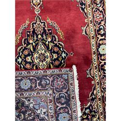 Persian rug, the red ground field decorated with floral design medallion and spandrels, guarded border with repeating floral design