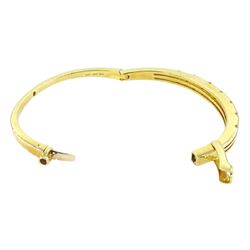 Roberto Coin 'Parisienne' 18ct gold three row round brilliant cut diamond bangle, with a signature round cut ruby to the underside and ruby set clasp, Birmingham 2006, boxed