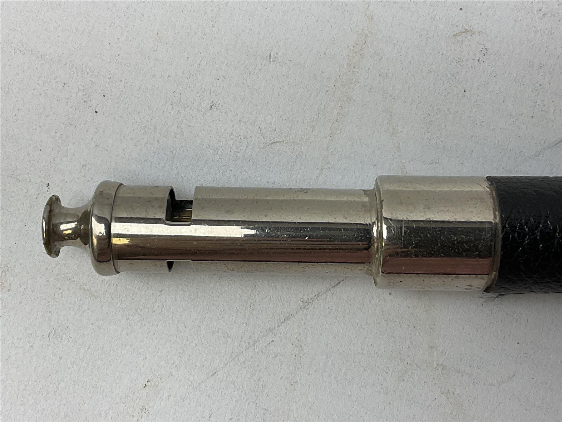 ‘The Metropolitan’ Police ebonised and black leather swagger stick, with combined whistle, 60cm