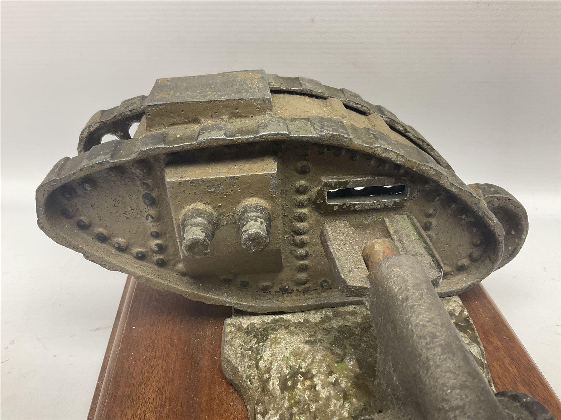 Early 20th century mechanical money bank 'Tank and Cannon' by Starkies, mounted on an oblong mahogany base with WW1 Tank Corps cap badge; patented 16th January 1919 L29.5cm
