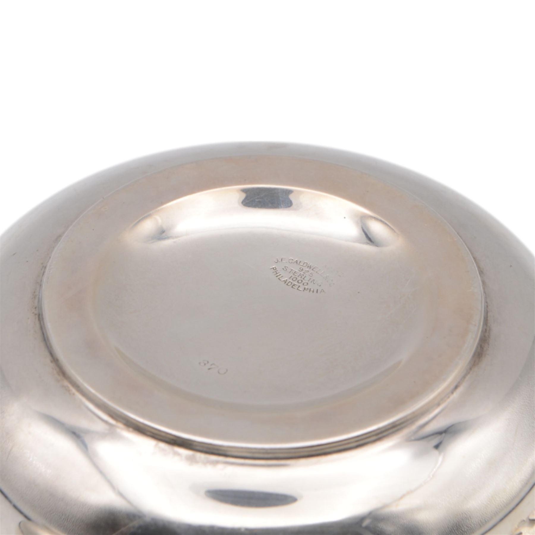 American silver porringer, after the original design by Paul Revere, of circular form with single pierced keyhole pattern handle, stamped J. E Caldwell & Co 925 Sterling Philadelphia, together with a similar miniature example, hallmarked London 1904, largest D11cm (2)