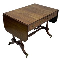 George III mahogany sofa table, rectangular drop-leaf top with reed moulded edge and rounded corners, fitted with two frieze drawers and two opposing false drawers, quadruple collar turned pillar supports on turned and block platforms, splayed and moulded supports with brass cups and castors 