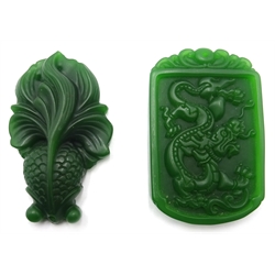  Five 20th century white, green and black jade pendants  