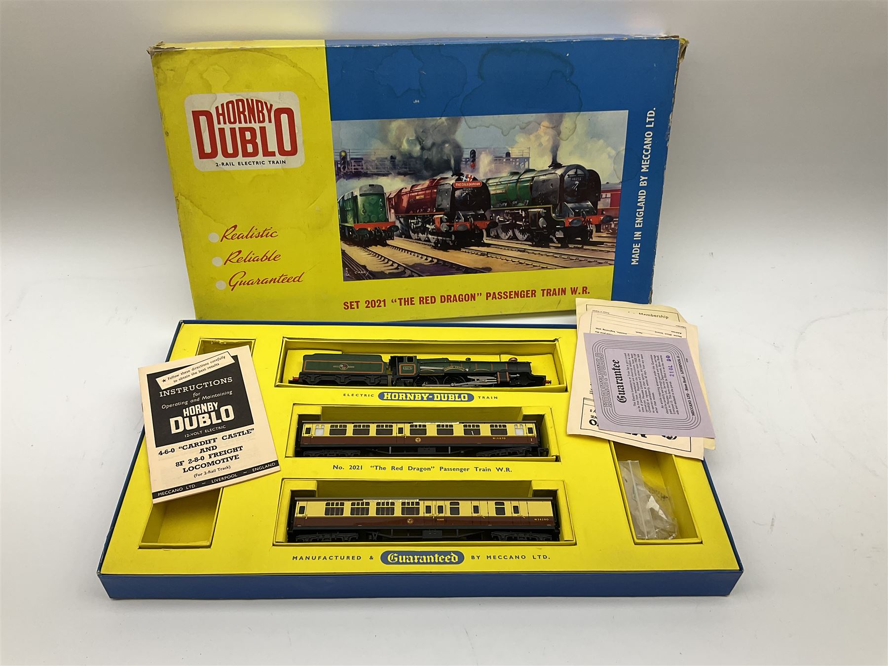 Hornby Dublo - two-rail set 2021 'The Red Dragon ' passenger train W.R. with Castle Class 4-6-0 locomotive 'Cardiff Castle' No.4075 and two coaches (no track), boxed with paperwork, Red Dragon headboard and oil tube; and two-rail set 2006 Tank Goods Train set with Class R1 0-6-0 tank locomotive No.31340 and two open wagons (lacking guards van) and track, boxed with instructions (2)