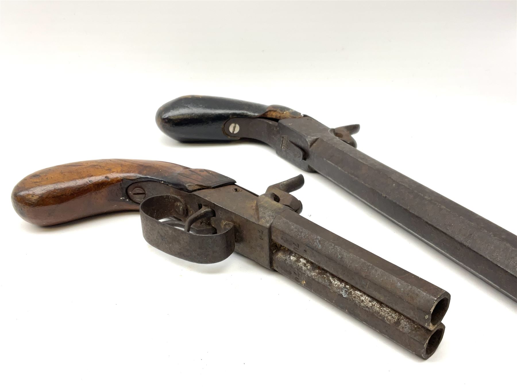 Mid-19th century percussion cap side-by-side double barrel pocket pistol with 7.5cm octagonal barrels and walnut bag stock L21.5cm; and Belgian 16-bore percussion cap pocket pistol with 16cm octagonal barrel, folding trigger and black painted wooden stock L27.5cm (2)