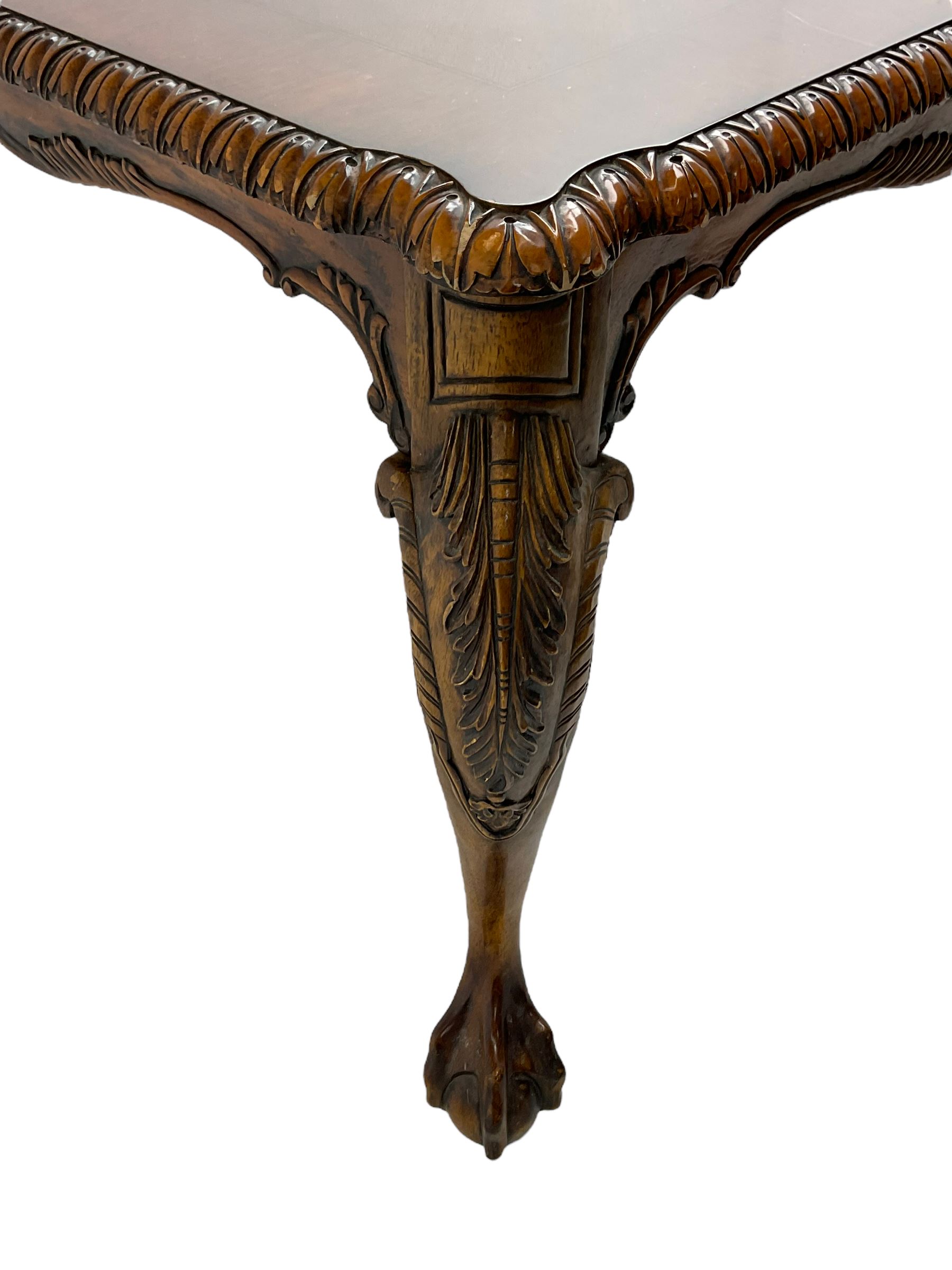 Chippendale Revival - hardwood extending dining table, rectangular gadroon carved top, on acanthus carved cabriole supports with ball and claw feet, with two additional leaves; together with a set of eight (6+2) dining chairs, shaped cresting rail over pierced and carved splat, upholstered drop-in seat, on acanthus carved cabriole supports with ball and claw feet