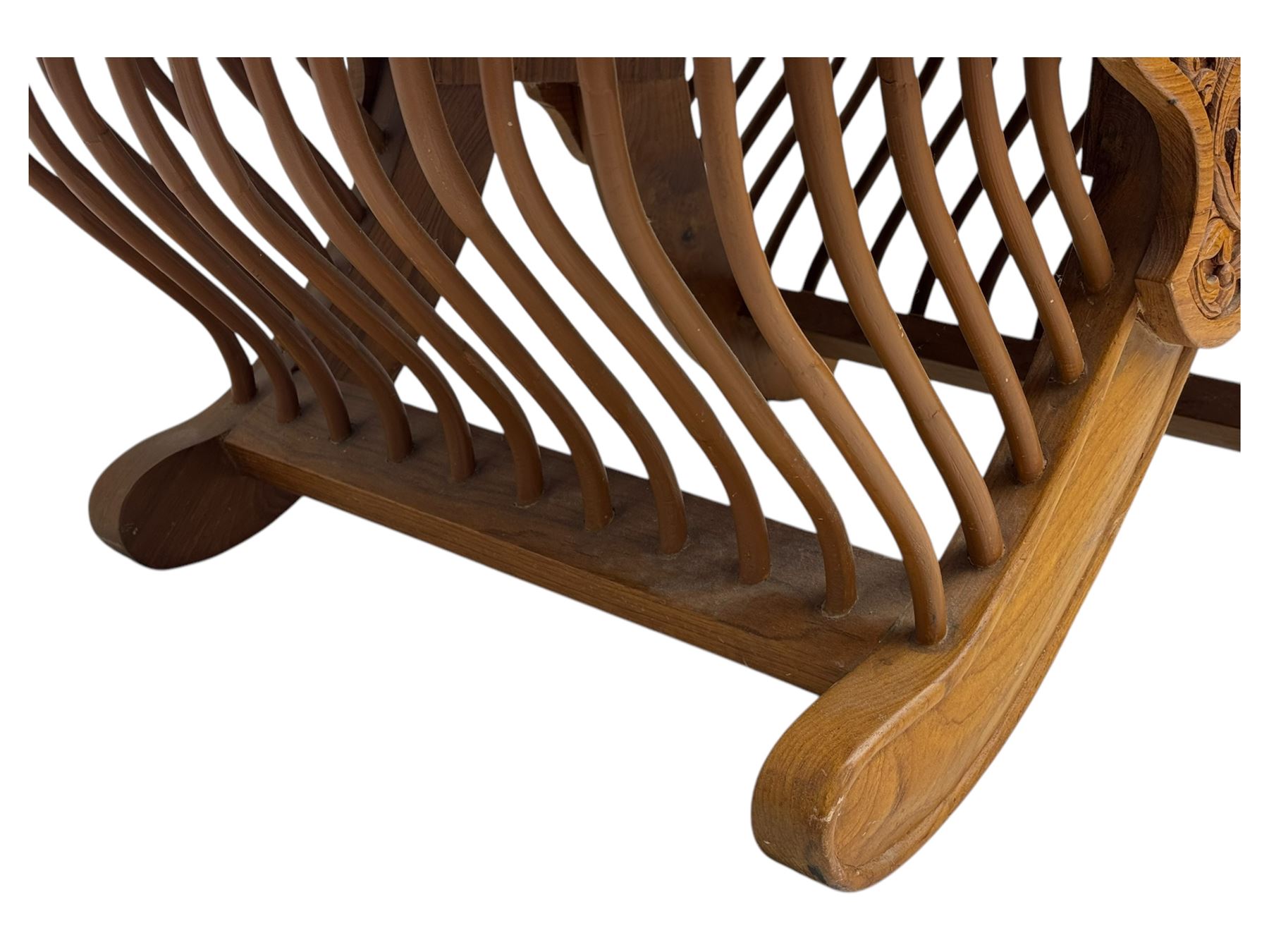 Early 20th century carved teak Howdah elephant chair, with pierced floral and foliate carved backrest, spindle gallery arm supports, cream upholstered cushions, splayed legs on a curved reeded base 