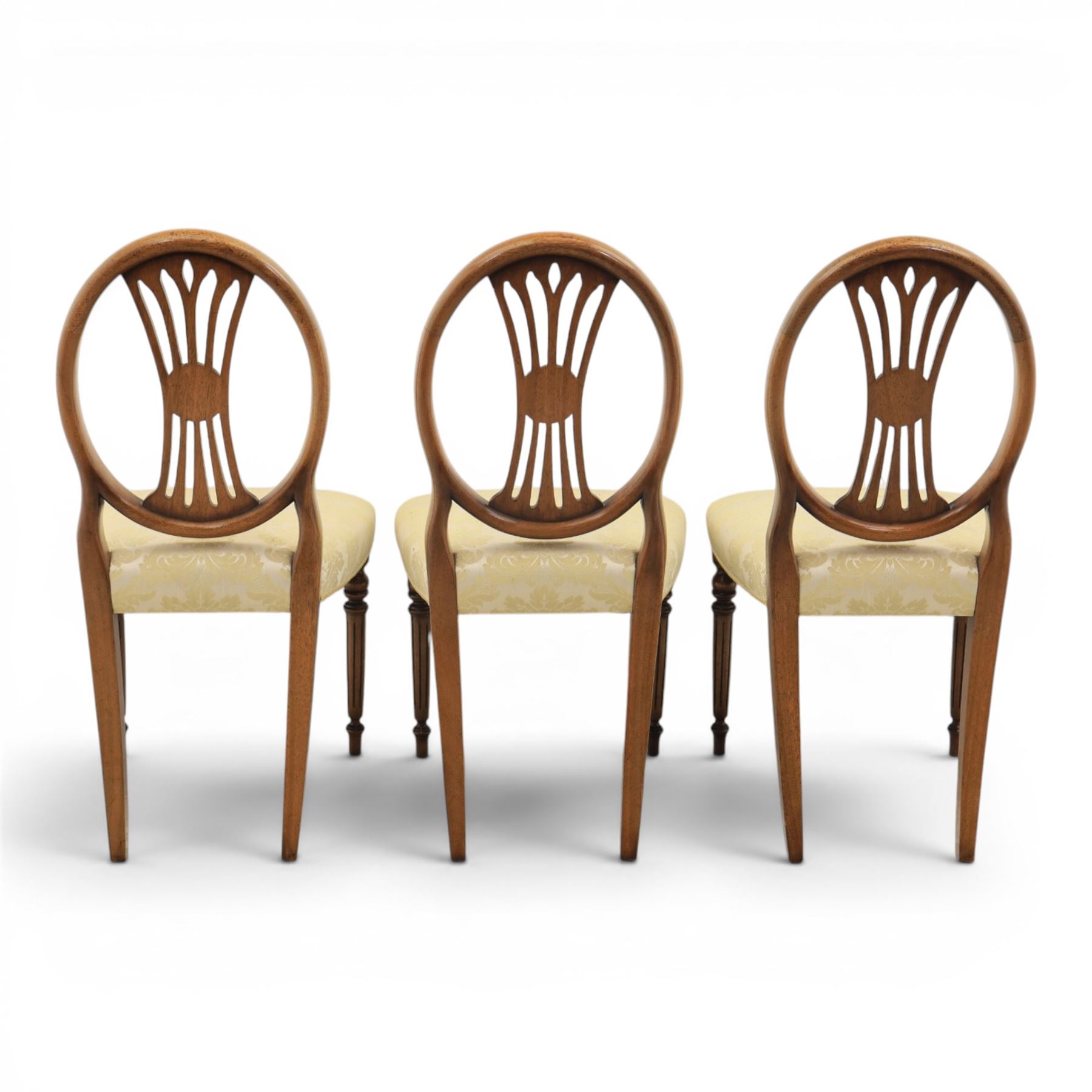 Bevan Funnell Reprodux - Regency design set of ten mahogany dining chairs, oval backs with central splat with rose motif, serpentine seat upholstered in damask fabric, raised on turned supports