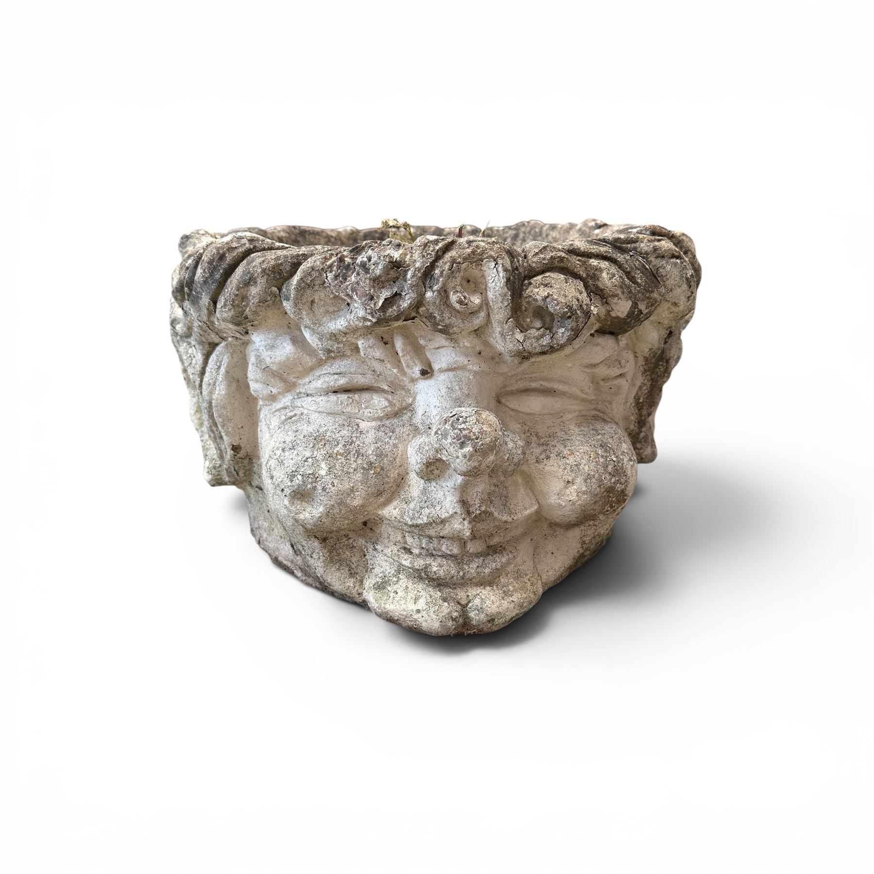 Five composition stone garden planters, comprising various circular and square forms with relief foliate decoration, together with a cylindrical lidded garden pot.
