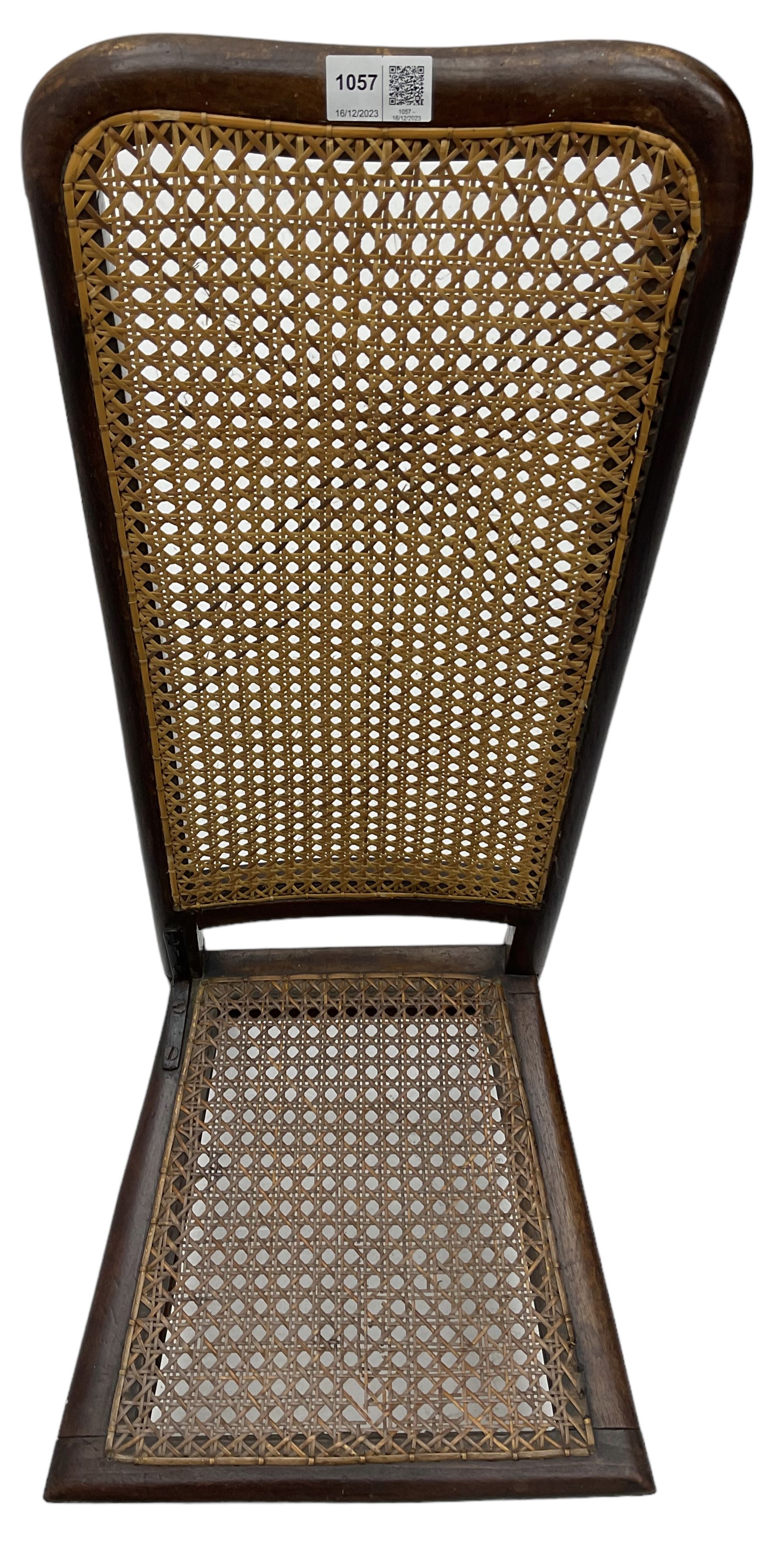 Early 19th century stained beech and mahogany child's correction chair, cane seat and back raised on turned supports united by stretchers